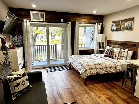 Queen Bed with Reclaimed Wood Accent Wall and Private Balcony | Lodge at Lincoln Station