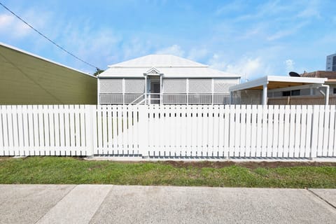 Tucked behind a classic white picket fence in the vibrant heart of town