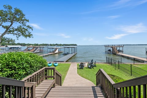 From the back porch, savor uninterrupted views of open water and your private dock—where luxury meets lakeside living.