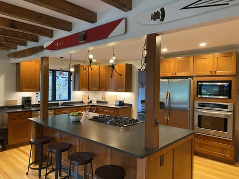 Large fully equipped kitchen with island seating.