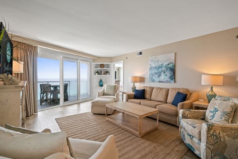 Living Room area includes a sleeper sofa, sitting chairs, and a large flat screen TV with cable. Door access to private balcony.

Professionally Managed by
Breathe Easy Rentals