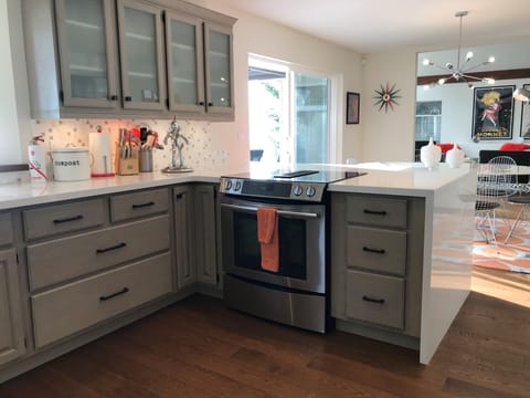 Open-concept kitchen with large peninsula is perfect for large family gatherings