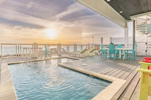 Your private pool deck awaits with turquoise waters and colorful seating, perfect for morning coffee or sunset cocktails.