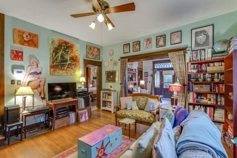 Settle into a living room packed with vintage charm, comfy seating, and warm hardwood floors.
