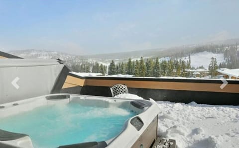 Soak in your private hot tub while snow-capped mountains create a breathtaking winter wonderland backdrop.