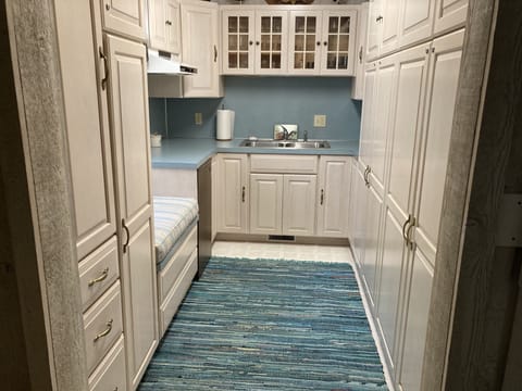 Kitchenette with plenty of cabinets,  a sink, and mini refrigerator