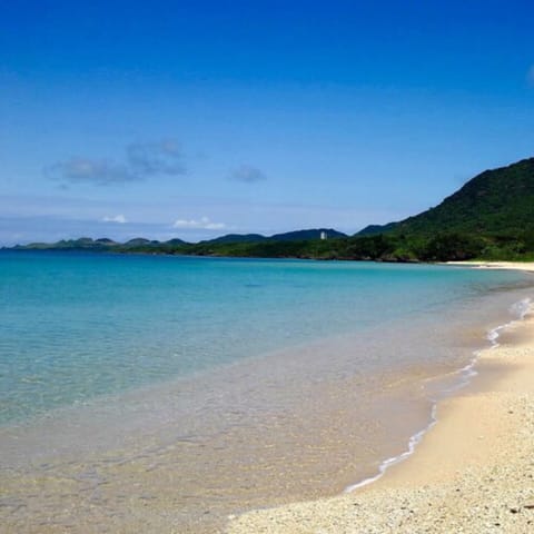 Beach nearby, white sand, beach umbrellas, beach towels