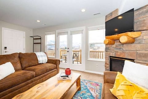 The living room boasts abundant natural light, a welcoming fireplace, and direct access to the balcony.