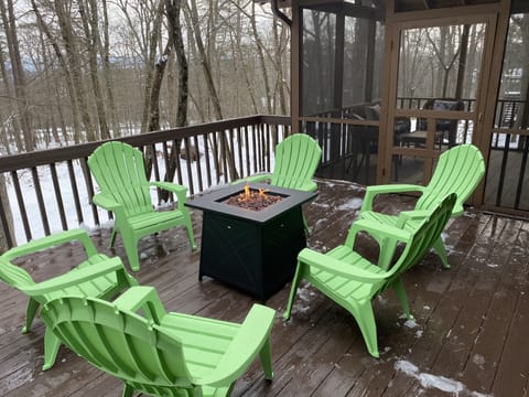 Propane fire pit table on spacious deck.