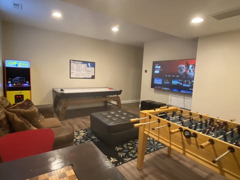 Game room with air hockey, foosball, arcade, chess table and a 75" Smart TV!