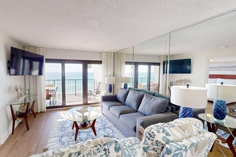 This well-furnished living room with a stunning view of the gulf creates a relaxing and inviting atmosphere.