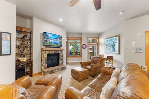 Sink into rich leather seating by your crackling stone fireplace, where mountain views meet home comfort.