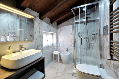 Shower, hair dryer, slippers, towels