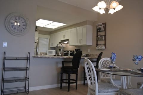 Well-equipped kitchen with pass-through window and cozy dining area.