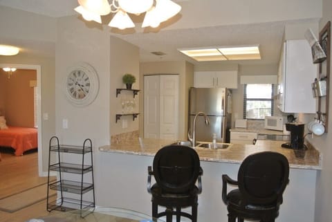 Open-plan kitchen with modern appliances and bar seating.