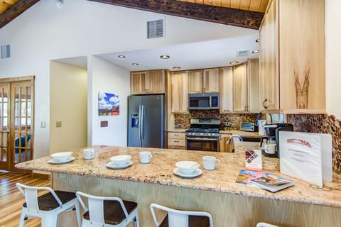 Ample Stone Counter Space Including Kitchen Bar Seating for Four