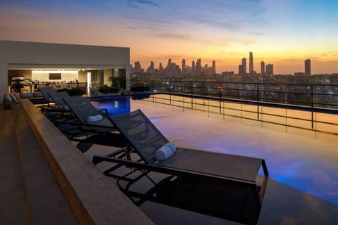 Outdoor pool, open 7:00 AM to 8:00 PM, pool umbrellas