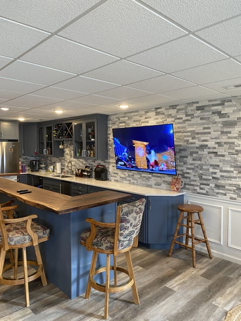 Lower level walkout wet bar with Refrigerator, Wine Cooler, Ice maker + 65” TV