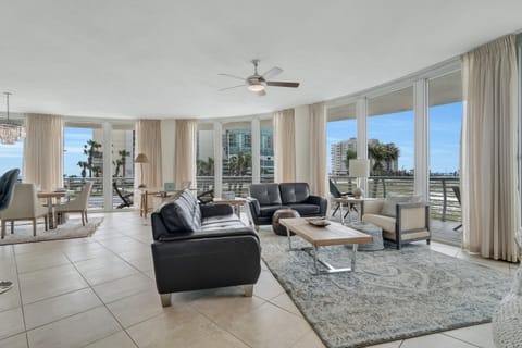 Spacious and inviting living area with floor-to-ceiling windows showcasing breathtaking panoramic views. This open-concept design seamlessly blends comfort and style, creating the perfect space for relaxation and entertainment.
