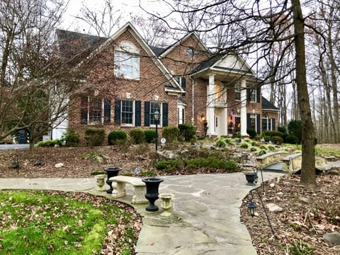 Beautiful home on 4 wooded acres, front & back patios, playground & long drivewy