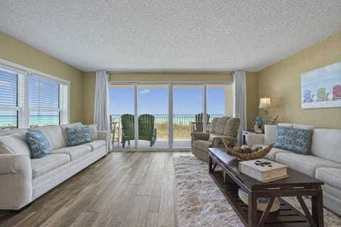 Step into the spacious living room of Cabana Club 101, where queen sleeper sofas and a smart TV face expansive sliding doors showcasing breathtaking Gulf views. Perfect for sunset watching or relaxing after a day on the sugar white sand.