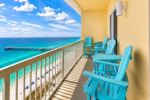 Sip your morning coffee from these turquoise Adirondack chairs while watching the endless ocean stretch before you.