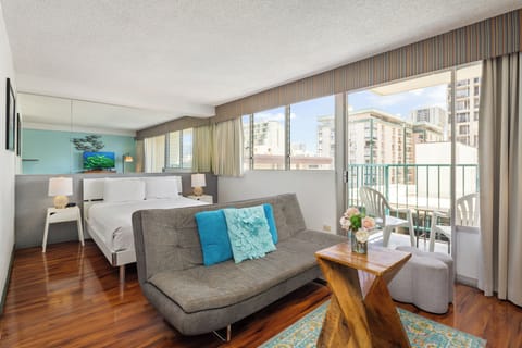 Step into your bright, open studio where a plush bed and cozy seating blend seamlessly. Floor-to-ceiling windows frame city views, while your private balcony invites morning coffee or sunset unwinding.