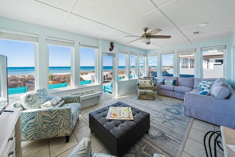 Relax in your bright coastal living room with panoramic ocean views from every window. The sea breeze flows through.