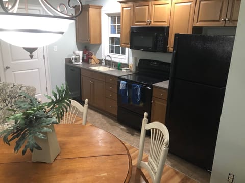 Full kitchen, table and chairs in lower level 2 bedroom suite