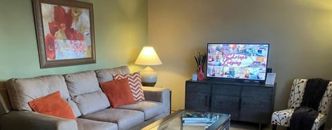 Cozy living room with plush seating and vibrant art