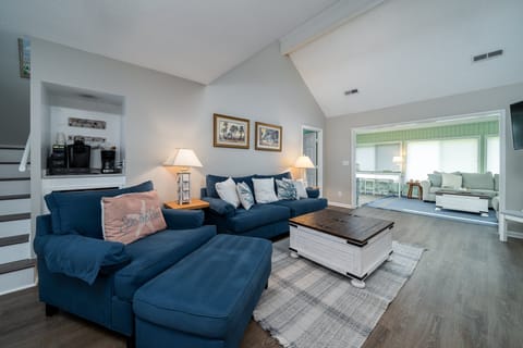 A large great room opens to the glass enclosed sun room