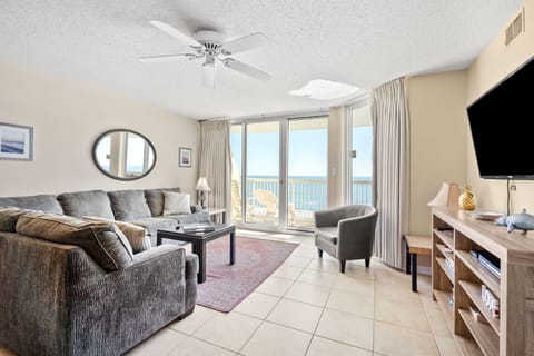 Sectional sofa and sliding doors to the ocean view at Sunrise Pointe 6G, a 3-bedroom condo from Thomas Beach Vacations