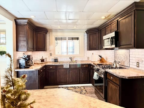 fully stocked kitchen with two sinks