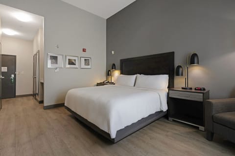 Premium bedding, desk, laptop workspace, blackout drapes