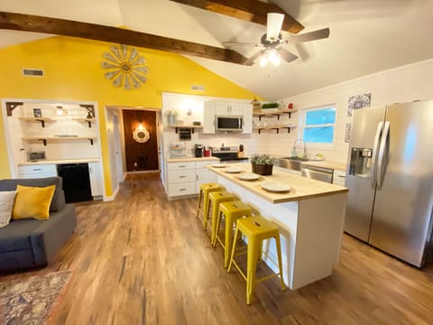 Open living space. Kitchen, built in bar with beverage fridge and living room 