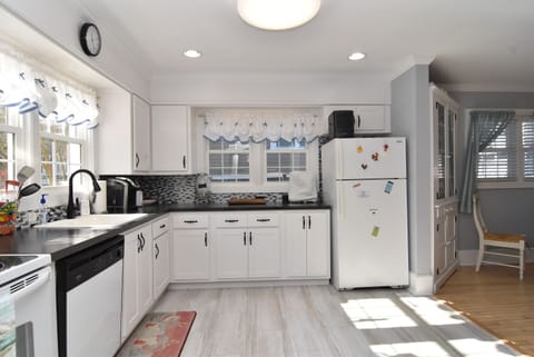 Another view of the kitchen as it leads into the dining area with seating for 10