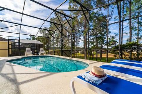 Pool view showing sun loungers and Pine tree views