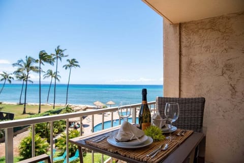 Balcony table set with wine and ocean views, the perfect start to a tropical evening.