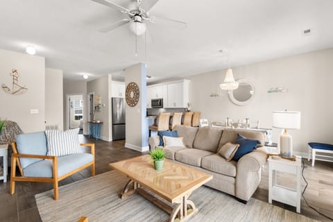 Unwind in this airy, coastal-chic living space where soft blues and natural textures create your perfect retreat sanctuary.