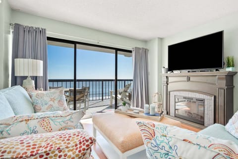 Sectional sofa framed by ocean views at Crescent Towers II 707, a 3-bedroom Crescent Beach condo from Thomas Beach Vacations