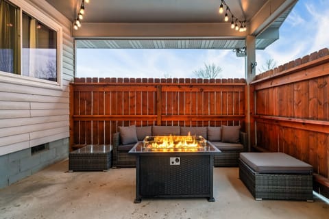 Gather around your modern fire pit on the covered back patio.