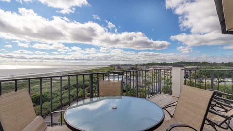 This stunning oceanfront view highlights the wide sandy shoreline and sparkling Atlantic waters just beyond the natural dune landscape.