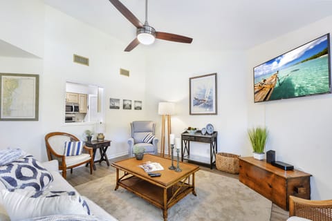 Living Room and Kitchen Pass-Through – Harbour Oaks 316 - Another angle of the Harbour Oaks 316 living room, with soaring ceilings, streaming TV, and a kitchen pass-through for easy entertaining on St. Simons Island.