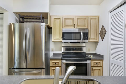 Updated Kitchen – Harbour Oaks 316, St. Simons - Harbour Oaks 316 features an updated kitchen with stainless steel appliances, full-size fridge, and microwave. Perfect for vacation meals on St. Simons Island.