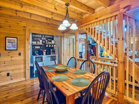 Dining table. Stairs leading up to loft or down to lower level.