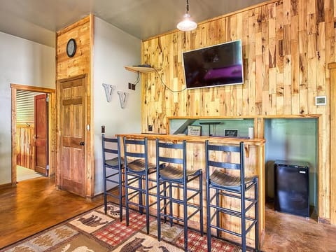 Bar area with Smart TV and mini fridge.