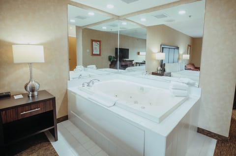 King Whirlpool Suite Accessible | Desk, laptop workspace, blackout drapes, iron/ironing board