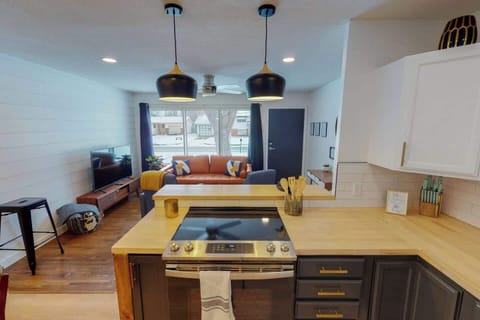 Kitchen opens into the living room with large picture windows - furniture updated