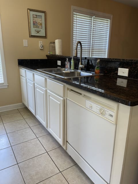 Dishwasher & double sink open to the dining area.