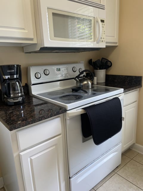 Full service kitchen with coffee pot, stove, oven & microwave.